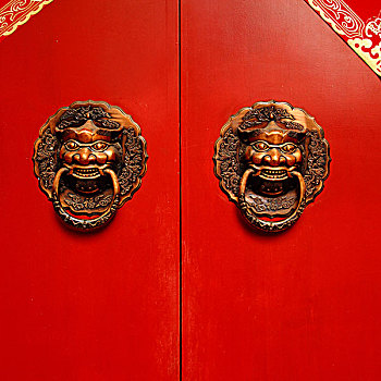 镶嵌青铜门环的红色中式大门