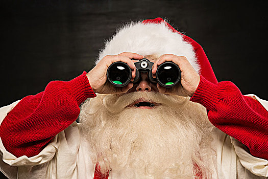 圣诞老人,双筒望远镜,深色背景