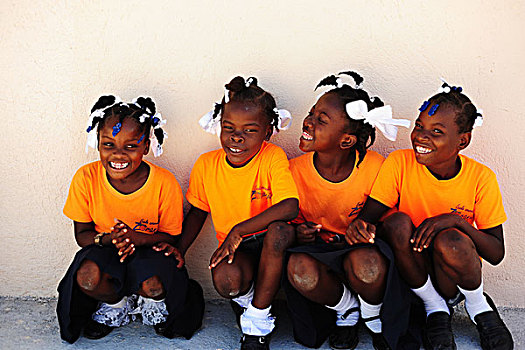 haiti,port,au,prince,portrait,of,4,schoolgirls,in,orange,uniform,smiling