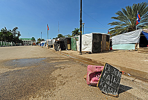haiti,port,au,prince,panel,asking,to,deposit,trash,here,in,champs,de,mars,camp,front,of,destroyed,presidential,palace