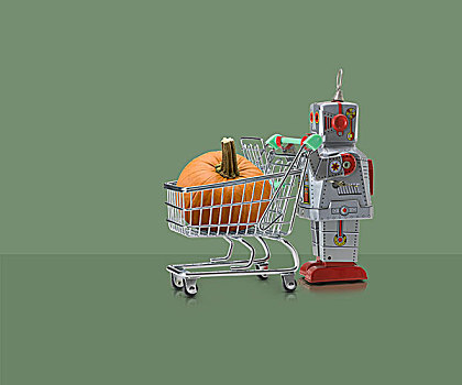 玩具,机器人,推,微型,购物车,南瓜,绿色背景