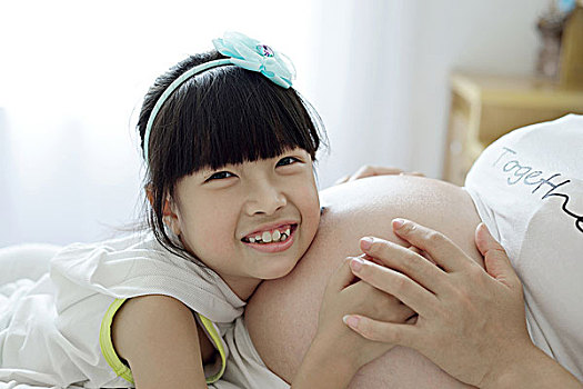 女孩粘在孕妇肚子上感受胎动