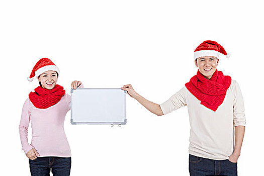 戴着圣诞帽的青年伴侣拿着白板