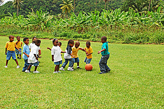 dominica,carib,territory,children,playing,soccer,at,a,school,fair,with,respect,yellow,t-shirt