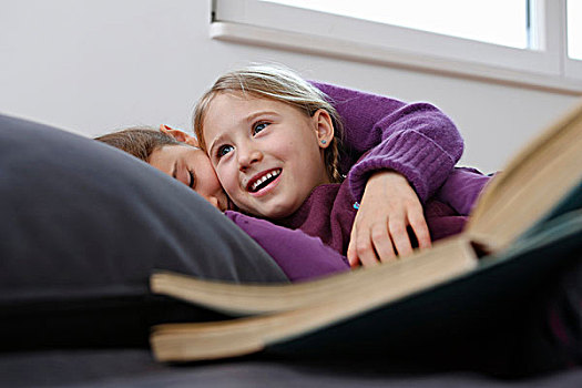 贴地拍摄,风景,女孩,躺下,沙发,书本,搂抱,微笑