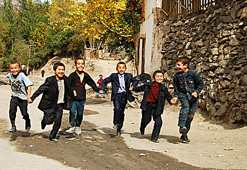 tajikistan,penjakent,girls,in,colorful,dress,running,and,smiling