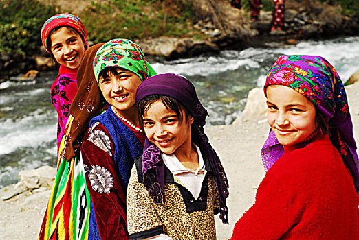 tajikistan,penjakent,group,of,girls,in,traditional,dress,by,the,river