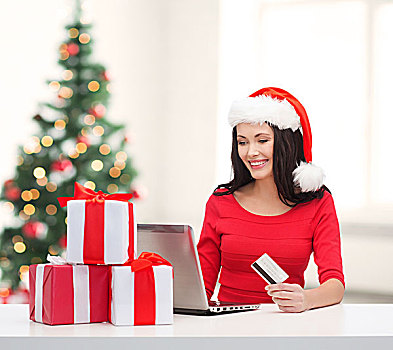 圣诞节,圣诞,网上购物,电子产品,概念,女人,圣诞老人,帽子,礼盒,笔记本电脑,信用卡