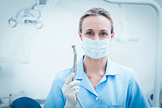 女性,牙医,手术口罩,拿着,牙科工具