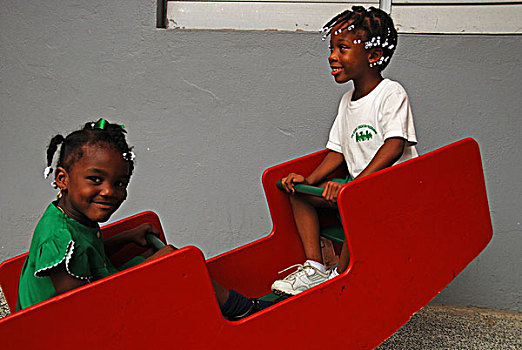 dominica,roseau,preschool,social,center,young,schoolgirls,playing,on,swing