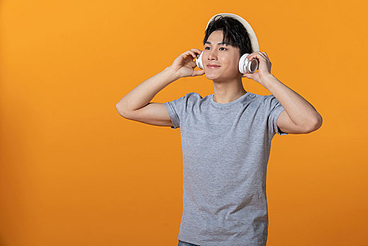 年轻男士戴着耳机听音乐