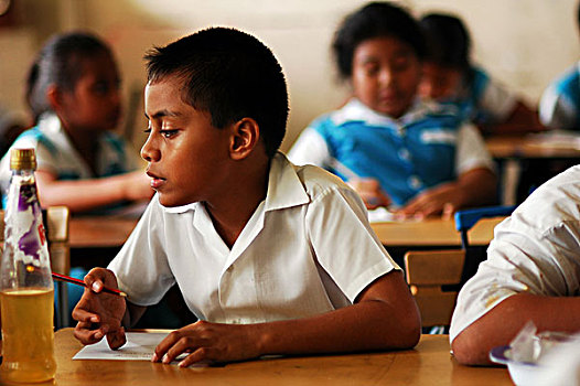 tuvalu,funafuti,schoolgirl,in,blue,uniform,writing,on,a,paper,the,classroom