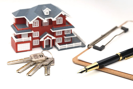 房屋模型,钥匙和钢笔放在白色背景上