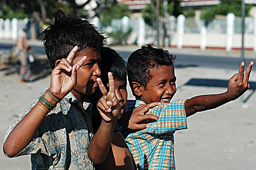 group,of,young,smiling,asian,boys,waving,at,the,camera