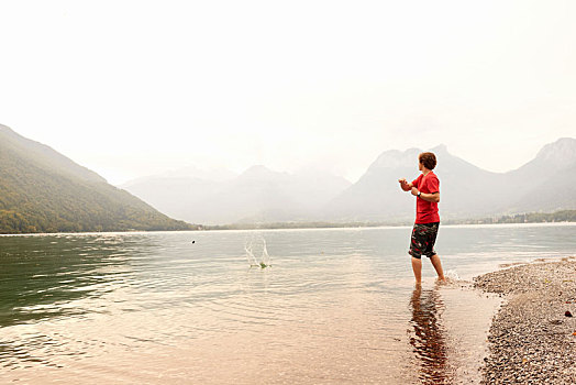 男青年,石头,湖,阿纳西,隆河阿尔卑斯山省,法国