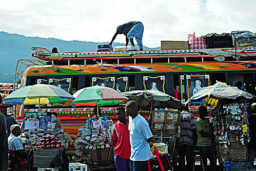 haiti,port,au,prince,bus,preparing,for,departure,at,station,with,market,stall,in,front