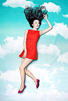 天空下穿红裙子的美女