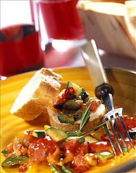 蔬菜杂烩,法式面包片,黄色板材,叉子