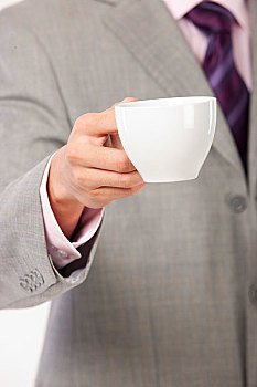 商务男士端着咖啡杯