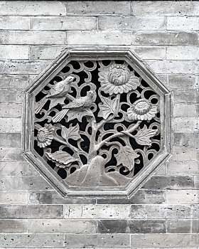 灰色砖墙上的中式传统漏花窗