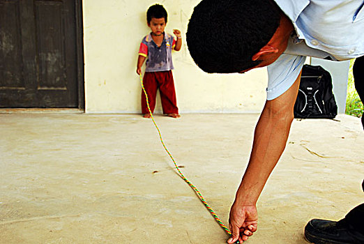 dominica,carib,territory,little,boy,with,colorful,necklace,playing,rope