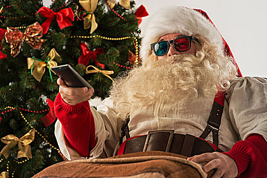 圣诞老人,坐,摇椅,靠近,圣诞树,在家,看电视,家庭影院,戴着,3d眼镜,拿着,遥控器