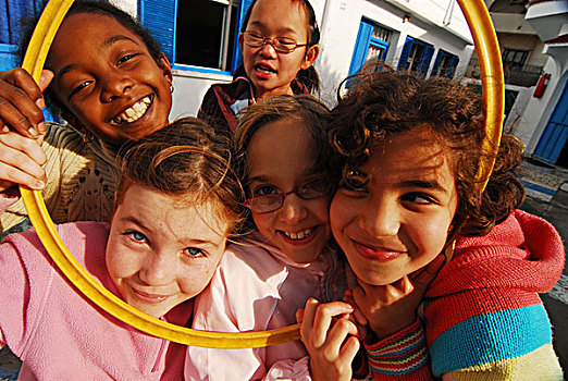 libya,tripoli,group,of,smiling,girls,looking,through,hula,hoop