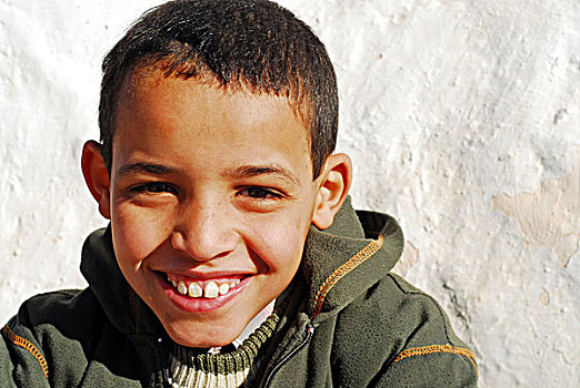 algeria,melika,close-up,portrait,of,a,smiling,boy,by,wall