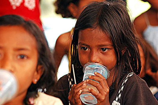 portrait,of,timorese,boy,with,plastic,glass,in,his,mouth