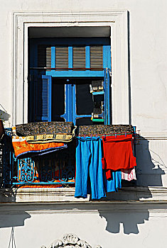 algeria,algiers,clothes,hanging,on,clothesline,for,drying,in,the,blue,balcony,of,residential,building