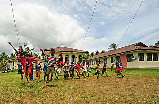 indonesia,sumatra,banda,aceh,indonesian,children,running,and,jumping,in,school,yard