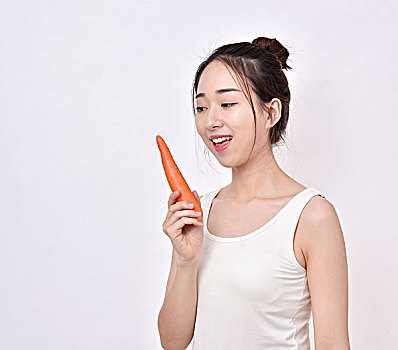 健康饮食,女性拿着一颗胡萝卜