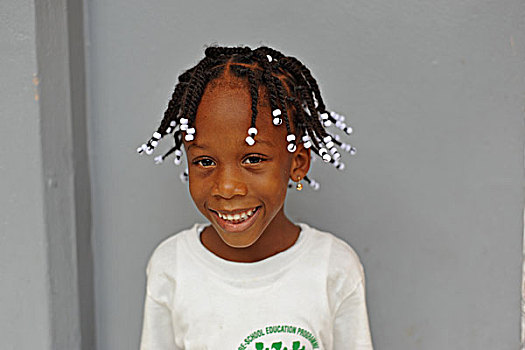 dominica,roseau,preschool,social,center,portrait,of,smiling,girl,with,braids