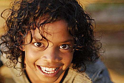 portrait,of,dark,skinned,boy,short,hair,and,white,tshirt