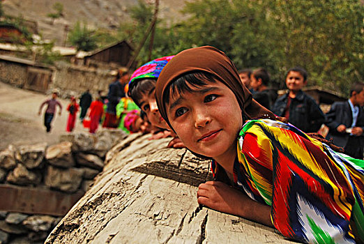 tajikistan,penjakent,group,of,local,girls,in,traditional,dress,posing,and,playing,by,the,river,on,wooden,bridge