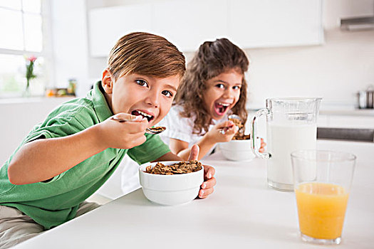 两个孩子,看镜头,吃饭,粮食,厨房