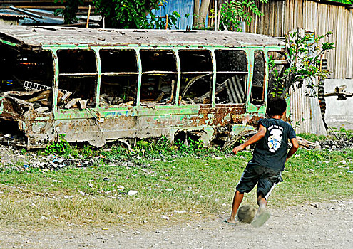 east-timor,timor-leste,dili,portrait,of,young,boy,with,sport,red,and,blue,shirt