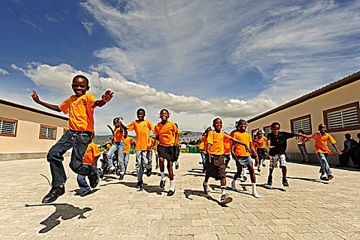 haiti,port,au,prince,children,with,orange,uniform,running,and,jumping