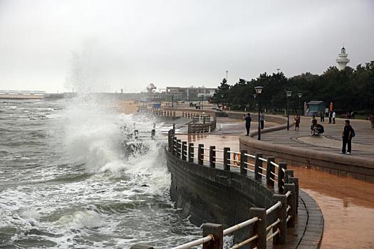 山东日照,海边掀起数米高大浪,游客拍照打卡感受清凉