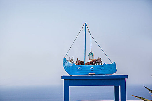 希腊圣托里尼伊亚岛屿民宿房顶上的蓝船