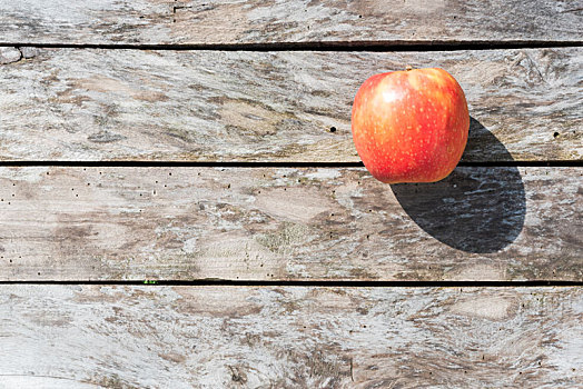 一个苹果在木纹桌上