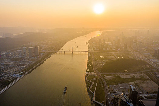 航拍夕阳下的广东珠海横琴地区珠澳十字门中央商务区