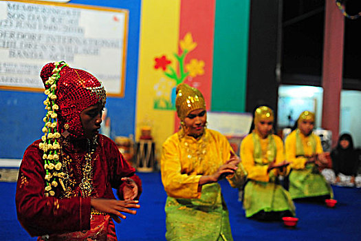 indonesia,sumatra,banda,aceh,children,performing,a,traditional,dance,in,tradiional,dress,at,sos,children