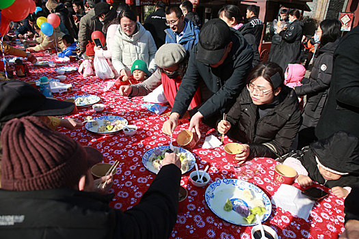 小镇摆下百米长桌宴,市民游客新年吃饺子交好运