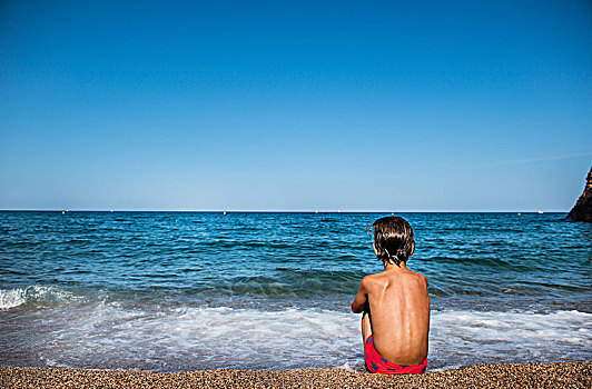后视图,男孩,坐,海滩,向外看,海上,加泰罗尼亚,西班牙