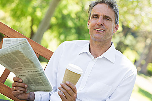 商务人士,拿着,报纸,咖啡杯,公园