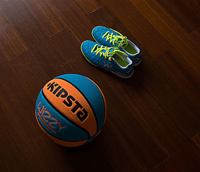 一个女孩在家里展示她新买的篮球和球鞋