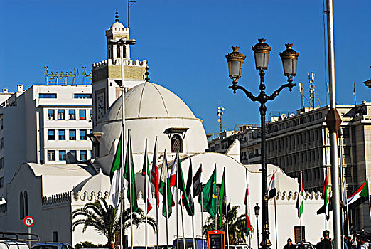 algeria,alger,view,of,metallic,lamp,with,variety,flags,and,jamaa-el-jedid,mosque,in,background,against,clear,sky