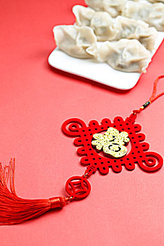 饺子中国结和剪纸放在红色背景上