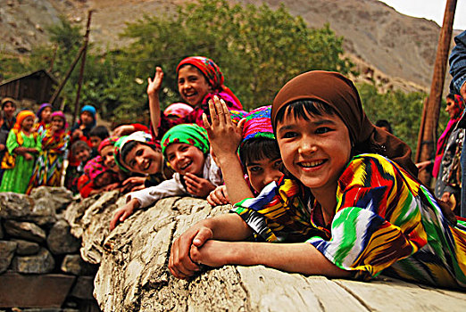 tajikistan,penjakent,group,of,local,girls,in,traditional,dress,posing,and,playing,by,the,river,on,wooden,bridge